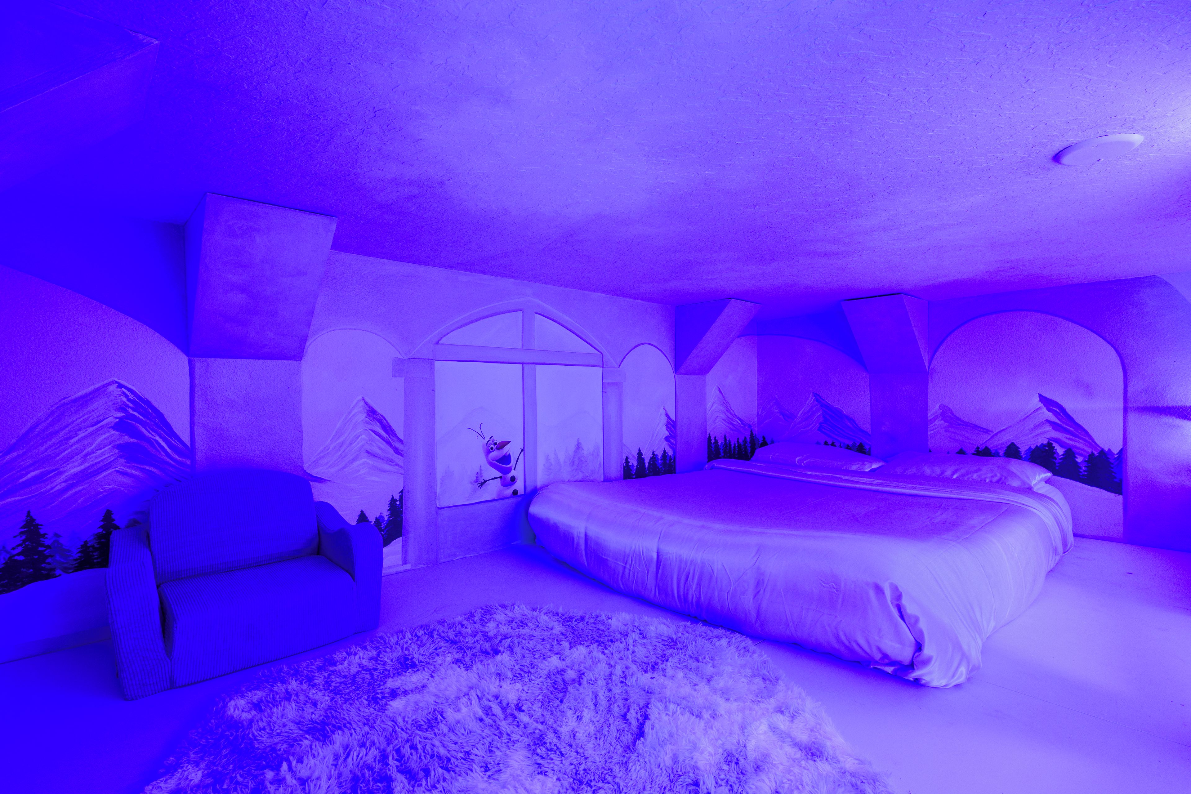 Un dormitorio con una cama grande, un sofá y una alfombra.