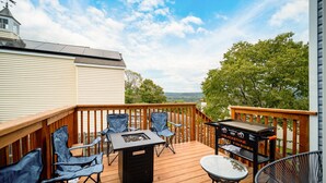 A deck with a fire pit, outdoor furniture, and a grill. - Sleek Escape: Modern 3 BR- 4 Min from West Point ! (Highland Falls)