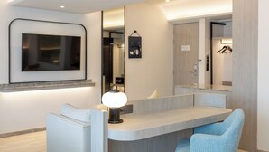 A modern bathroom with a vanity, a mirror, and a wall-mounted TV. - Cloudotel Walking Street Pattaya  (Pattaya)