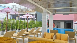 A rooftop lounge with wicker furniture, a pool, and potted plants. - Cloudotel Walking Street Pattaya  (Pattaya)