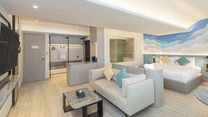 A modern hotel room with a sofa, a bed, a TV, a bathroom, and a large window. - Cloudotel Walking Street Pattaya  (Pattaya)
