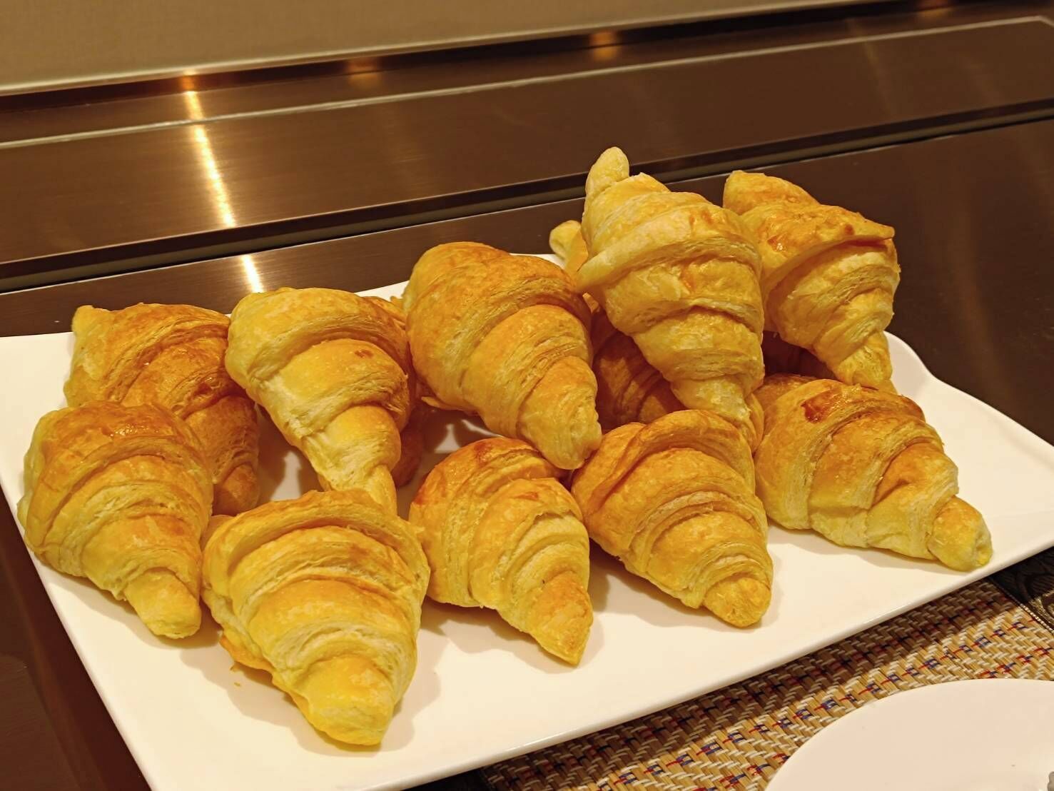 A plate of croissants on a white plate.