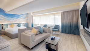 A hotel room with a bed, a sofa, a coffee table, a TV, and a window with curtains. - Cloudotel Walking Street Pattaya  (Pattaya)