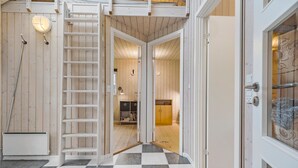 A room with a checkered floor, a white door, and a wooden interior.