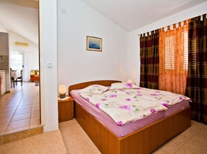 Relax in comfort with a large bed, a nightstand, and a framed picture on the wall.