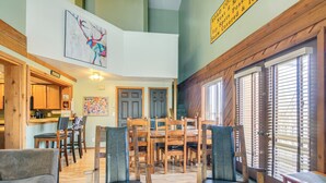 A spacious living area with a dining table, multiple chairs, and a sofa. - Mtn-View Condo w/ Trail Access in Brian Head (Brian Head)