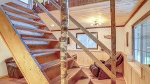 A wooden staircase with a birch tree trunk in the center, leading to a lofted area with a window and a ceiling light. - 6 Mi to Slopes: Forest-View Haven in West Dover! (West Dover)