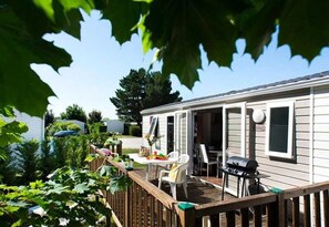 Enjoy al fresco dining on the deck with a barbecue grill and comfortable seating.