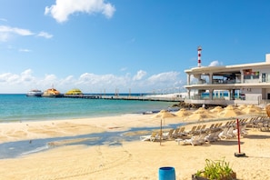 Overlooking the beach, this hotel features a multi-level building with balconies and a lighthouse.