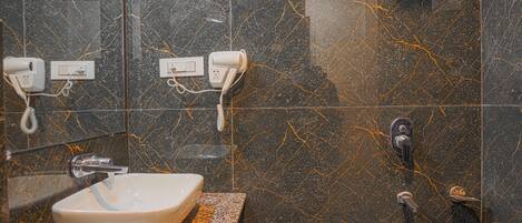 Un baño con lavamanos, espejo y ducha.