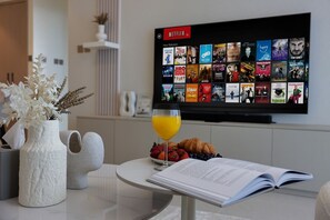 A flat-screen TV displaying a Netflix interface with a selection of movies and TV shows. - New 1BR | Burj Khalifa Infinity Pool | Dubai Mall (Dubai)