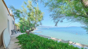 A coastal hotel with a pool, outdoor seating, and a view of the sea. - Beachfront Villa Mihovil With Direct Beach Access (Kastela)