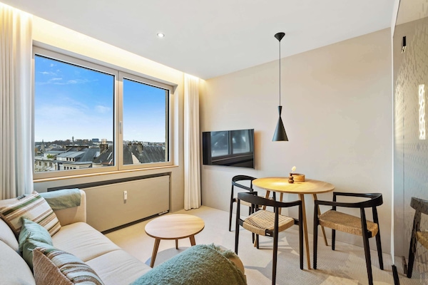 Cozy Dining and Relaxation Area – A compact and inviting space featuring a stylish dining table and seating for two.