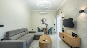 Luxury Apartment, City View | Living area | 43-inch Smart TV with cable channels
