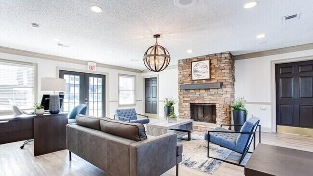 A modern interior with a fireplace, seating area, and a desk with a lamp. - Barcelo at East Cobb Q5 1 Bd 1Bth Newly furnished (Marietta)