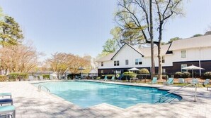 A swimming pool with lounge chairs and a building in the background. - Barcelo at East Cobb Q5 1 Bd 1Bth Newly furnished (Marietta)