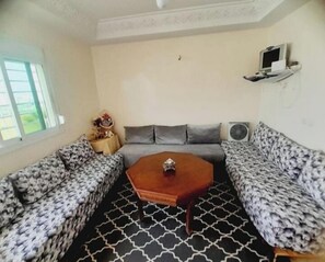 Apartment, City View | Living area | Flat-screen TV