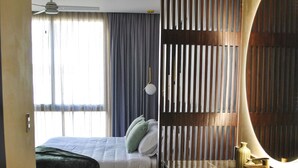 A hotel room with a bed, a bathroom with a sink and mirror, and a view of the outside. - New Chic Tulum with Rooftop Pool (Tulum)