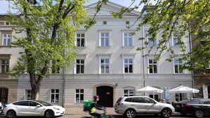 A building with a symmetrical facade, multiple windows, and a central entrance.