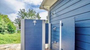A blue house with a white door and a star decoration. - Book Now for Fall! Short Walk to Beach! Hot Tub! (Panama City Beach)