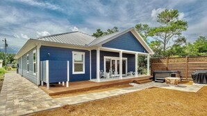 A single-story house with a covered porch, a barbecue area, and a fenced yard. - Book Now for Fall! Short Walk to Beach! Hot Tub! (Panama City Beach)
