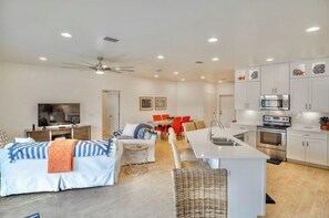 Relax in a comfortable living space with a sofa set and flat-screen TV, perfect for leisure and daily activities.