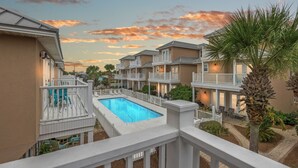 A residential complex with a swimming pool, balconies, and a landscaped garden. - Escape to Sand Dollar Holler: Coastal Retreat, 3 Beds, 2.5 Baths, Sleeps 10! (Panama City Beach)