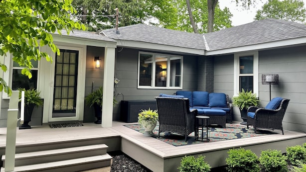 A house with a covered patio, outdoor seating, and a small garden area. - A Step Away: The Retreat – Walk to Town Escape (Saugatuck)