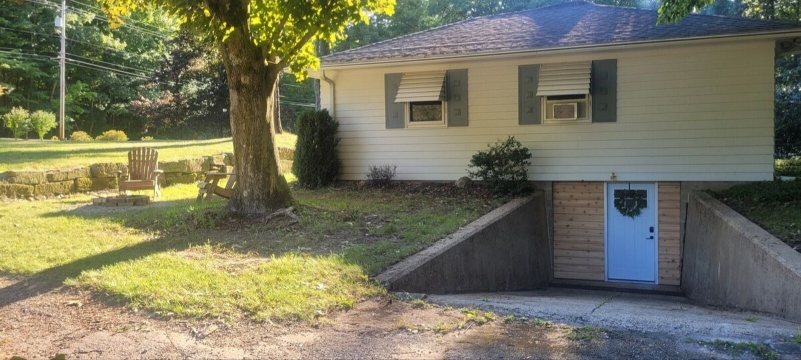 A single-story house with a front porch, a small front yard, and a garage.