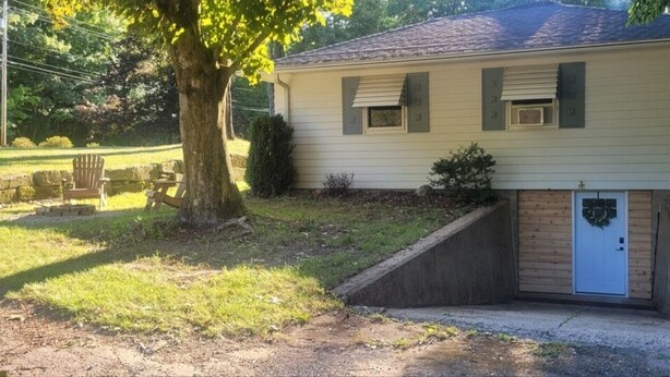 A single-story house with a front porch, a small front yard, and a garage.