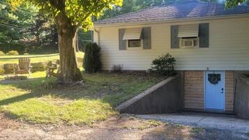 A single-story house with a front porch, a small front yard, and a garage.