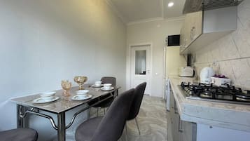 Family Condo, City View | Private kitchen | Full-size fridge, microwave, stovetop, electric kettle