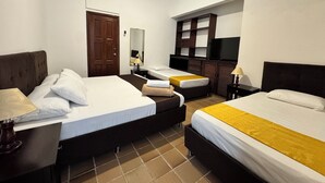 A hotel room with two beds, a TV, a mirror, and a wardrobe. - Boulevard del Rio Hotel (Cali)