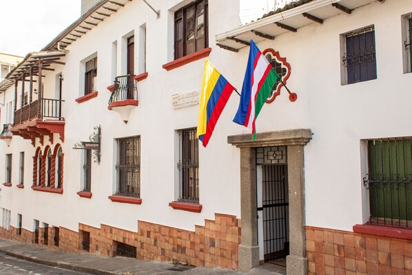 A building with balconies, a sign reading "Boulevard de los Siete Hostales," and flags. - Boulevard del Rio Hotel (Cali)