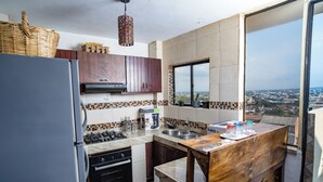 A kitchen with a refrigerator, stove, sink, and wooden counter. - Casa Colonial San Antonio, ideal for family and friends (Private parking)  (Cali)