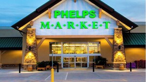 The exterior of a Phelps Market with a modern design, featuring a prominent sign and a large entrance. - Large porch offers beautiful views of the lake. Enjoy unique interior design! (Mannford)