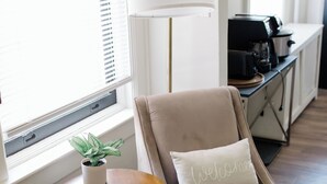 A room with a beige armchair, a small table with a plant, a lamp, and a 'Welcome' pillow. - Close to Wellspan, York College, Appell! Washer/dryer in unit. (York)