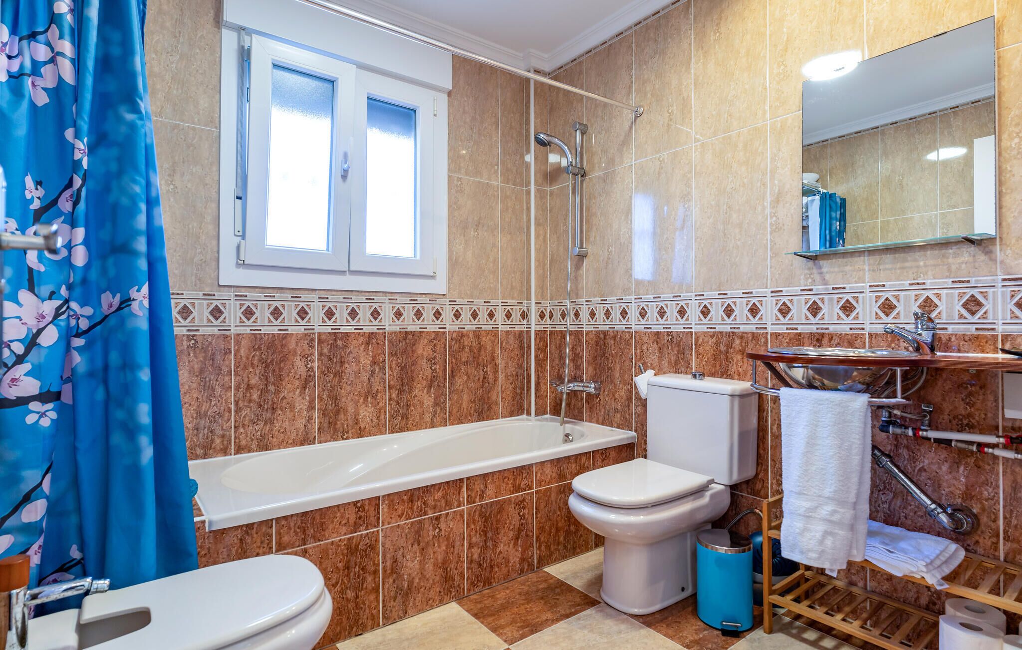 A bathroom with a bathtub, toilet, and shower.