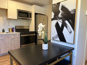 Dishwasher, coffee/tea maker, cookware/dishes/utensils, dining tables