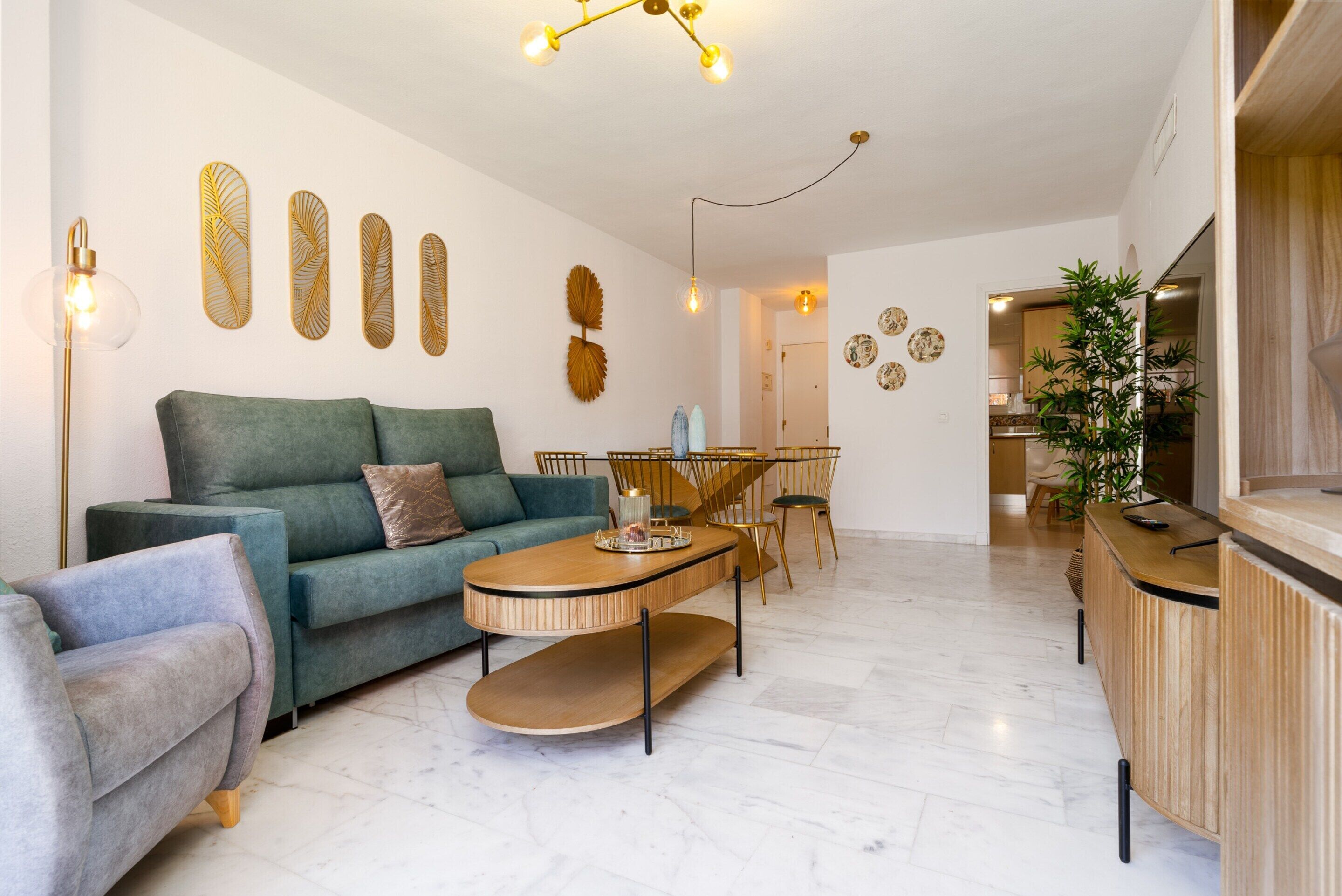 A modern living room with a sofa, coffee table, and dining area.