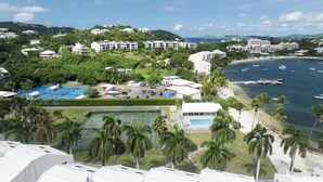 A coastal hotel with multiple buildings, a tennis court, and a pool. - Beachfront, Ocean Views, 2 bed, Poolside, Gym (St. Thomas)