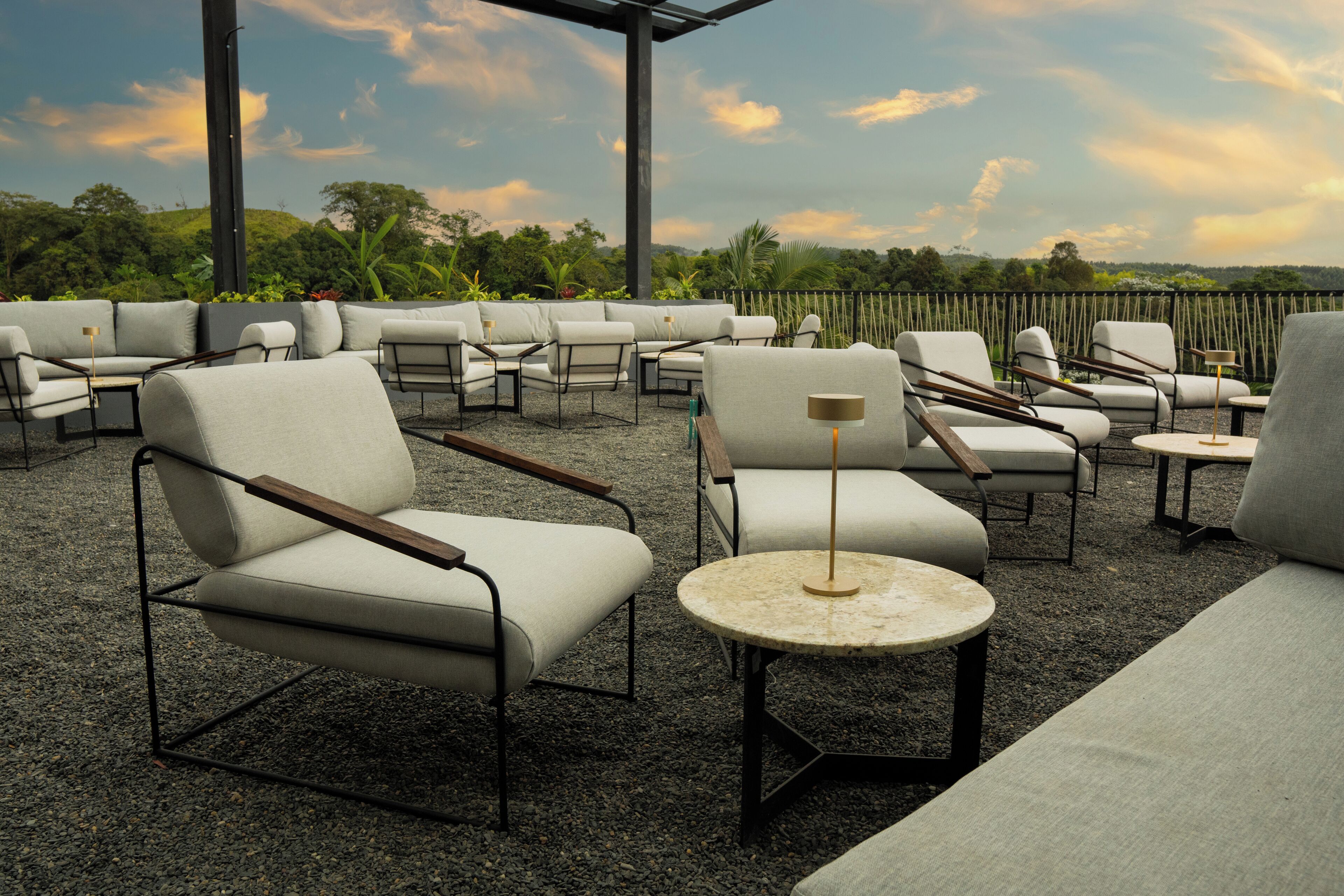 An outdoor seating area with modern furniture and a view of the landscape.