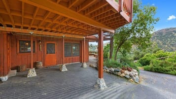 Traditional structure with a covered porch, surrounded by a serene natural landscape.