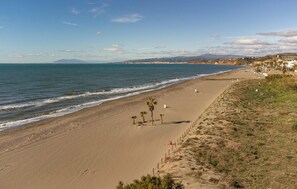 Guests can enjoy a serene beach experience with gentle waves and stunning views of the surrounding landscape.