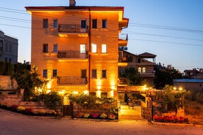 A multi-story building with balconies, a gated entrance, and a sign indicating 'Cappadocia Yamak Stone House.' - Yamak Stone House (Urgup)