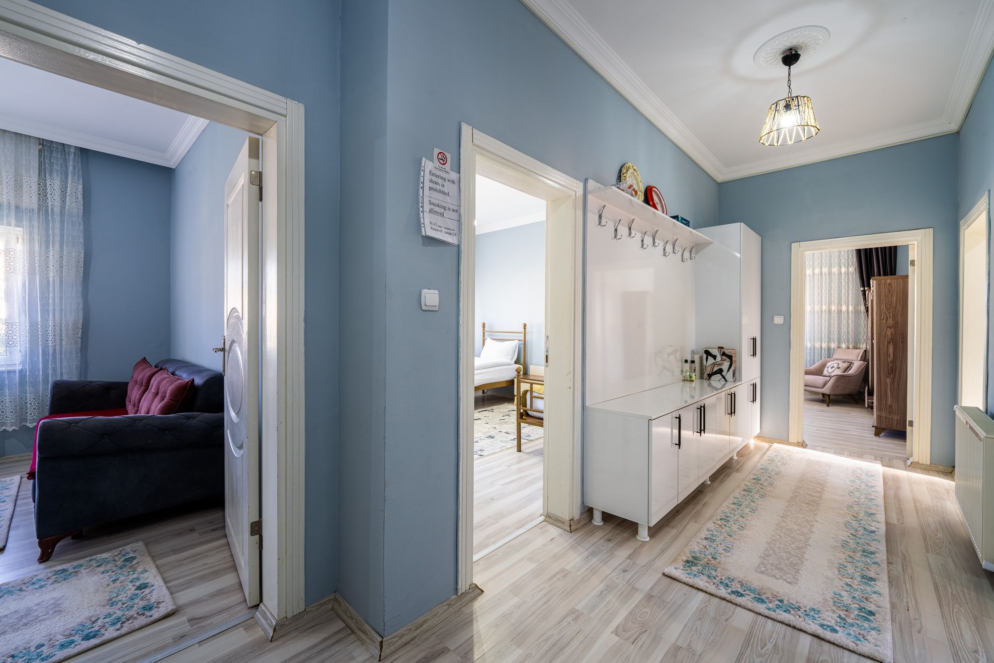 A room with a bed, a wardrobe, a desk, and a chair.