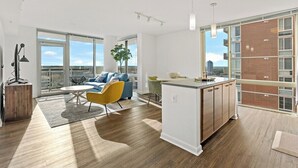 A modern apartment with a living area, dining space, and kitchen.