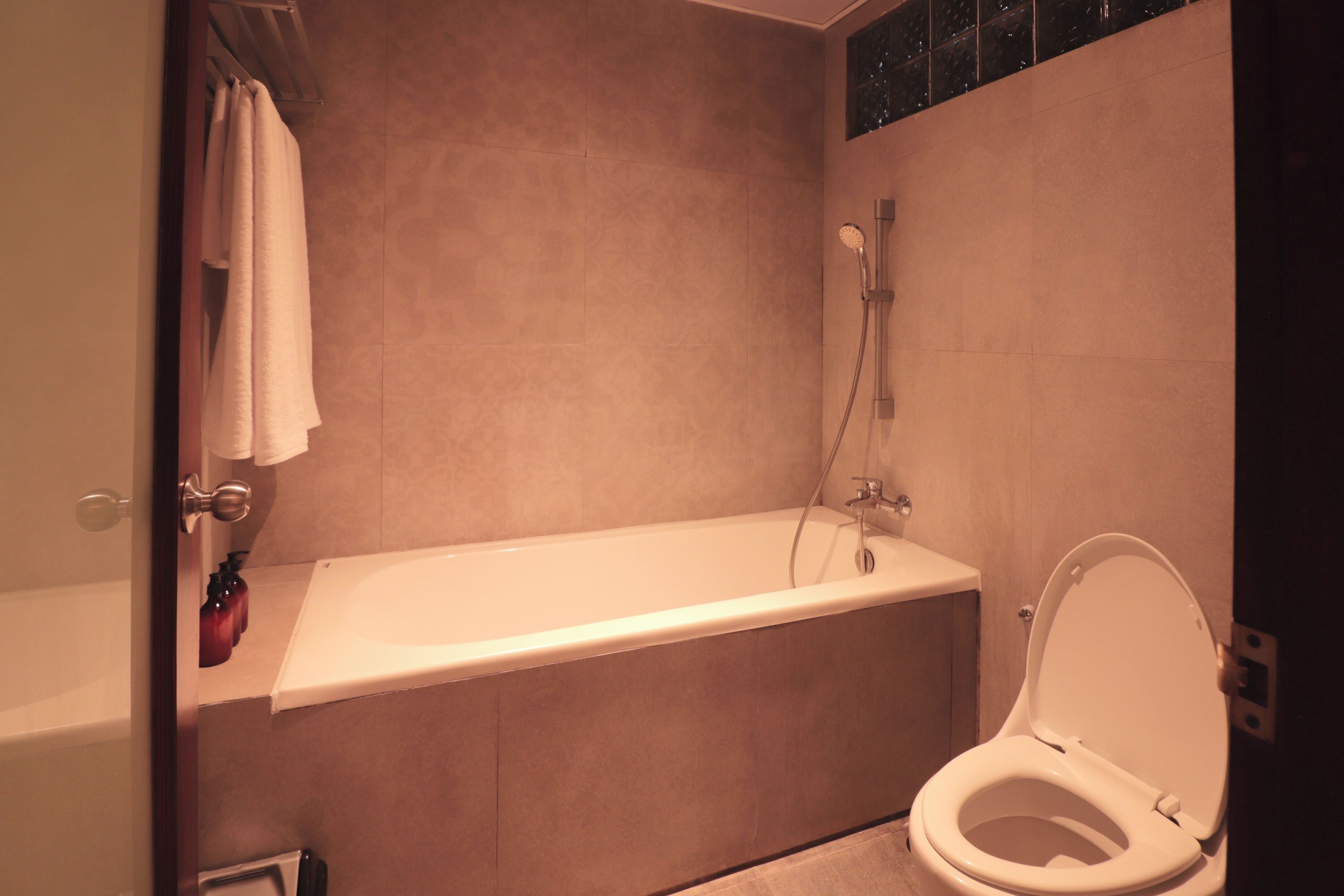 A bathroom with a bathtub, toilet, and shower.