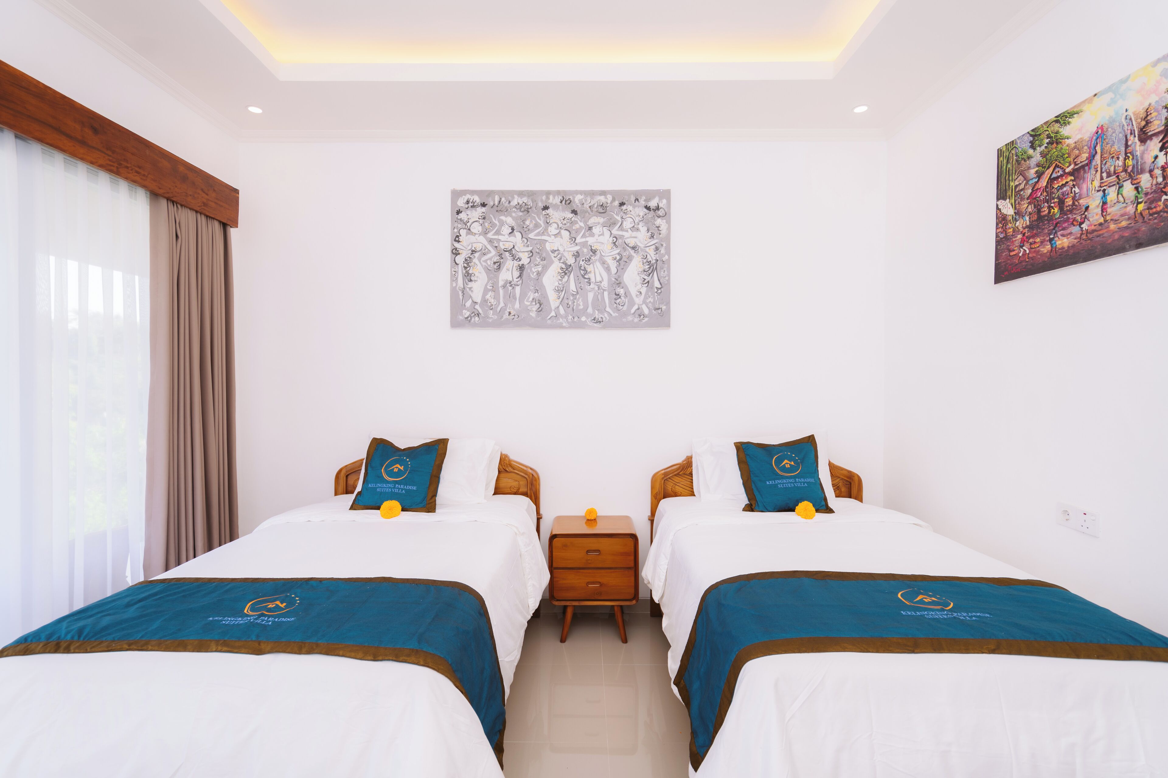 A hotel room with two beds, a nightstand, a painting, and a window with curtains.