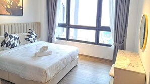A modern hotel room with a large bed, a bedside table, a window with curtains, and a painting on the wall. - Comfort Suite At Agile  (Kuala Lumpur)